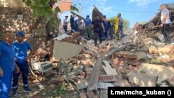 Emergency personnel work at the scene of the destroyed shopping center in Apsheronsk on July 22.