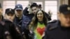 Alexandra (Sasha) Skochilenko, a 33-year-old artist and musician, is escorted inside a court building in St. Petersburg, Russia, on November 16.