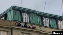 Students took shelter on a high ledge during the shooting in Prague.
