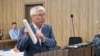 Former Kazakh Culture Minister Arystanbek Mukhamediuly speaks in court on June 16.