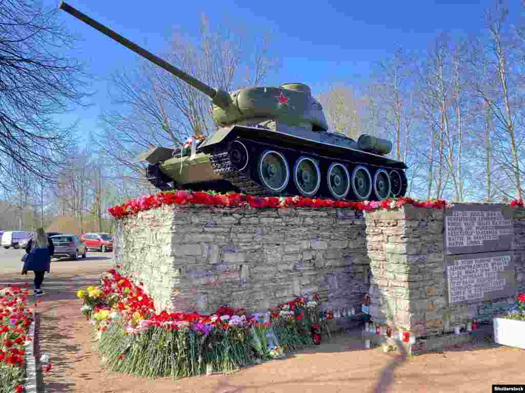 A Soviet T-34/85 Tank in Narva, Estonia, on the border with Russia that marked the 1944 capture of Narva from Nazi forces, photographed in May 2022. The tank was hauled off its plinth and taken to a local museum in August 2022. In response to the controversial removal of the tank, Russian authorities installed a nearly identical monument in Ivangorod, just across the river border with Estonia, one month later. 