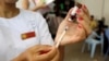 A nurse prepares a measles-rubella vaccine. Romania has seen a continuous decrease in the number of children vaccinated against measles prompted by anti-vaccination campaigns on social media. 
