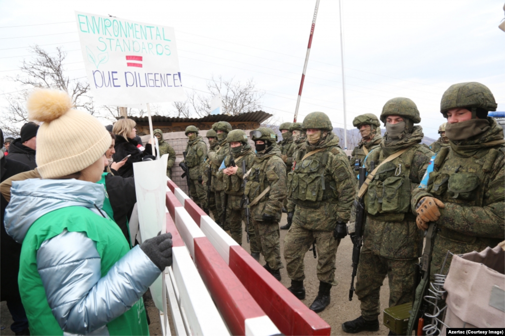 Russian peacekeepers face Azerbaijanis blocking the highway connecting Nagorno-Karabakh to Armenia on December 13. (Photo by Azertac) Dozens of Azerbaijanis first blocked the road, known as the Lachin Corridor, on December 12. The group declared themselves “eco-activists” who were protesting the extraction of gold by ethnic Armenians from mines in surrounding areas of Azerbaijan. Spontaneous protests are routinely broken up within minutes by police in Azerbaijan, and many have accused Baku of staging the Lachin protest to put pressure on Yerevan and Karabakh Armenians. 