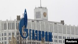 Russia -- The company logo of natural gas producer Gazprom is seen on an advertisement in front of the White House in Moscow, 08Feb2013