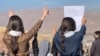 Three Iranian girls show their solidarity with protesters in the Kurdish city of Mahabad earlier this month amid the nationwide protests.