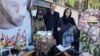 Pejman Gholipur's parents at his grave. "Tell us who killed our children.... We lost our loved ones in our own homeland," his mother told an international people's tribunal.