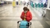A passenger checks her mobile phone at Belgrade's Nikola Tesla airport.