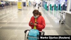 A passenger checks her mobile phone at Belgrade's Nikola Tesla airport.