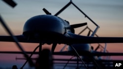 Long-range drones of Ukraine's defense intelligence stand in line before takeoff at an undisclosed location.