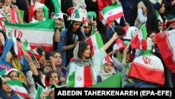 Iranian women cheer during the FIFA World Cup qualier between Iran and Cambodia in Tehran in 2019.