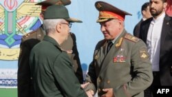 Russian Defense Minister Sergei Shoigu meets with the chief of staff of Iran's armed forces, Mohammad Bagheri, in Tehran on September 19. 
