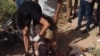 An injured cyclist receives treatment at the scene of the deadly attack in southern Tajikistan