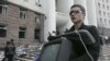 Moldova -- A young man carries a stolen TV, property of parliament during the anticommunist demonstration in Chisinau, 07Apr2009