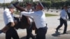 A protester is arrested in Almaty.