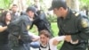 Police detain a protester during the unsanctioned demonstration on May 21.