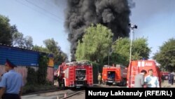 Emergency services work at the scene in Almaty on July 18.