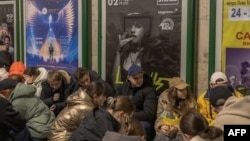 People take shelter in a Kyiv subway station during an air alert in the Ukrainian capital on November 25.