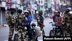 Indian security personnel question motorists during curfew-like restrictions in the city of Jammu on August 5. 