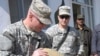 U.S. soldiers inspect opium seized at a border post near Herat, Afghanistan.