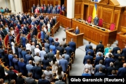 Ukrainian lawmakers take their oath of office during the first session of the newly-elected parliament in Kyiv on August 29.