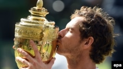 Andy Murray of Britain kisses the championship trophy after winning the Wimbledon Championships at the All England Lawn Tennis Club, in London in 2016.