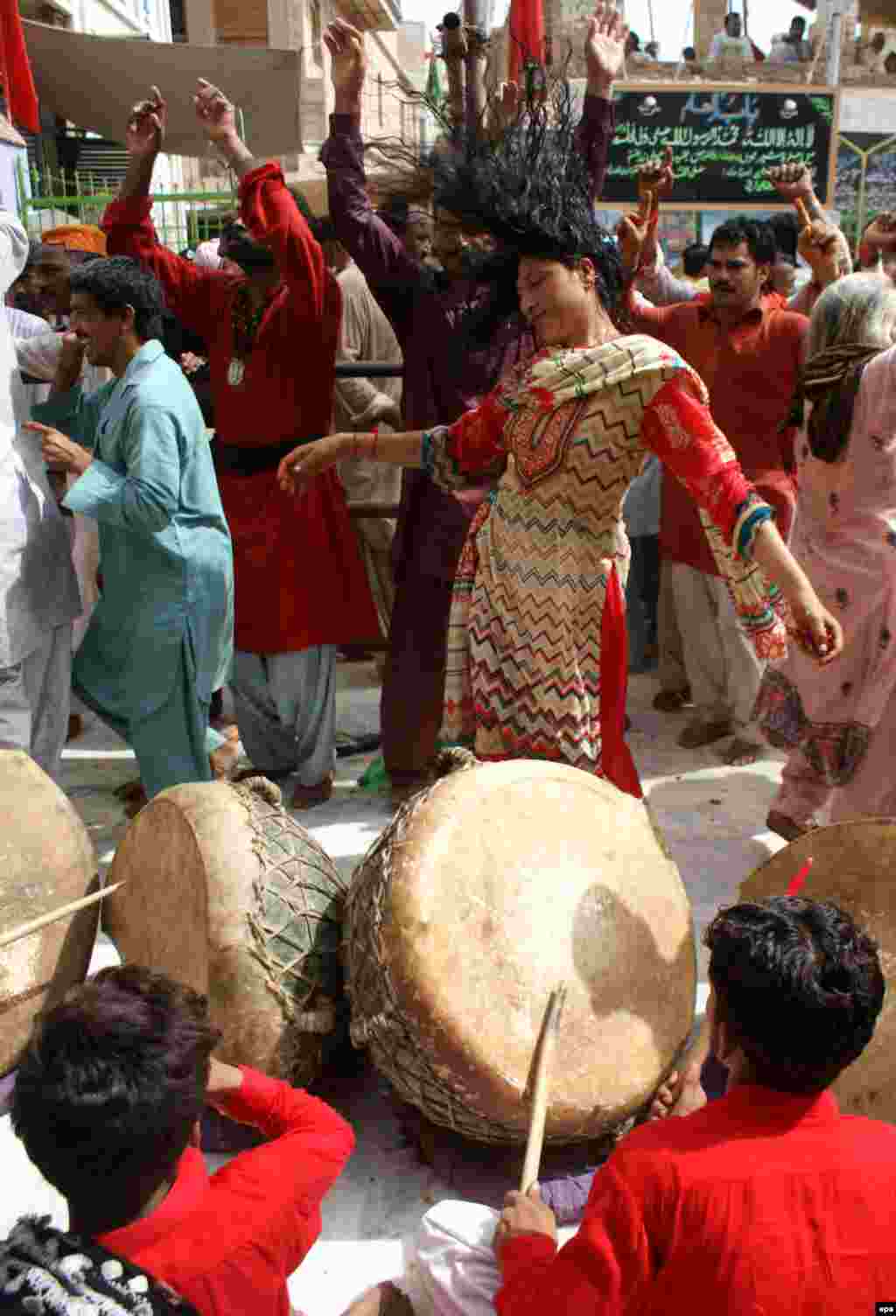 A Sufi woman dances during the annual celebrations at the shrine in 2012. The devotees describe themselves as the "Anti-Taliban" and stand for "love, tolerance and the great infinity." 