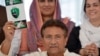 Former Pakistani President Pervez Musharraf holds a copy of his party manifesto for the forthcoming general election at his residence in Islamabad on April 15.