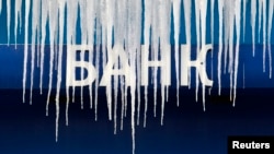 Icicles hang from a board displaying the VTB Bank logo outside an office in central Moscow