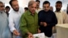 Shahbaz Sharif (center), the younger brother of ousted Pakistani Prime Minister Nawaz Sharif, casts his vote in the general elections.
