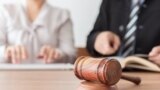 Judge gavel with lawyers having team meeting at law firm in background. Concepts of law,legal advice and services,online auction