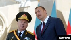 The most notable change in the new cabinet is the absence of Safar Abiyev (left, seen with President Ilham Aliyev at a military parade in 2011), who has served as defense minister.