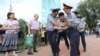 Law enforcement officers detain a man during an opposition protest in Almaty.