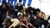 Tunisian immigrants who arrived on the Italian island of Lampedusa wait to board a boat for temporary accomodation on February 17.