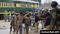 Pakistani police officers and paramilitary soldiers guard the site of a fatal attack in Quetta on February 14.