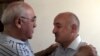 Musavat party deputy leader Arif Hajili (right) is greeted by an acquaintance in Baku after his release from prison on June 22.