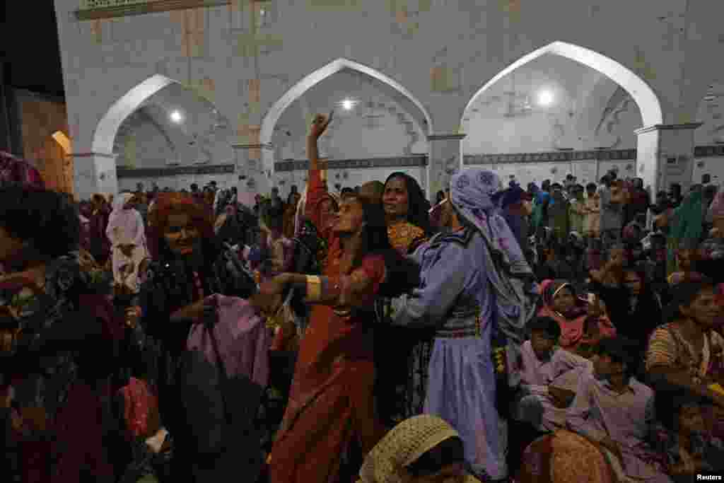 A woman devotee dances in a trance inside the shrine in 2013. Lal Shahbaz Qalandar, the Sufi saint interred here, is revered by both Sufi Muslims and Hindus. 