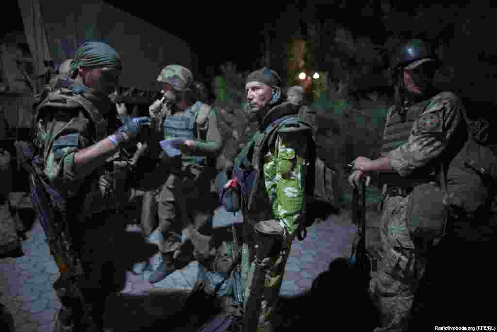 Soldiers prepare for a raid on enemy positions.