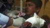 An injured student receives treatment at a Peshawar hospital following the attack.